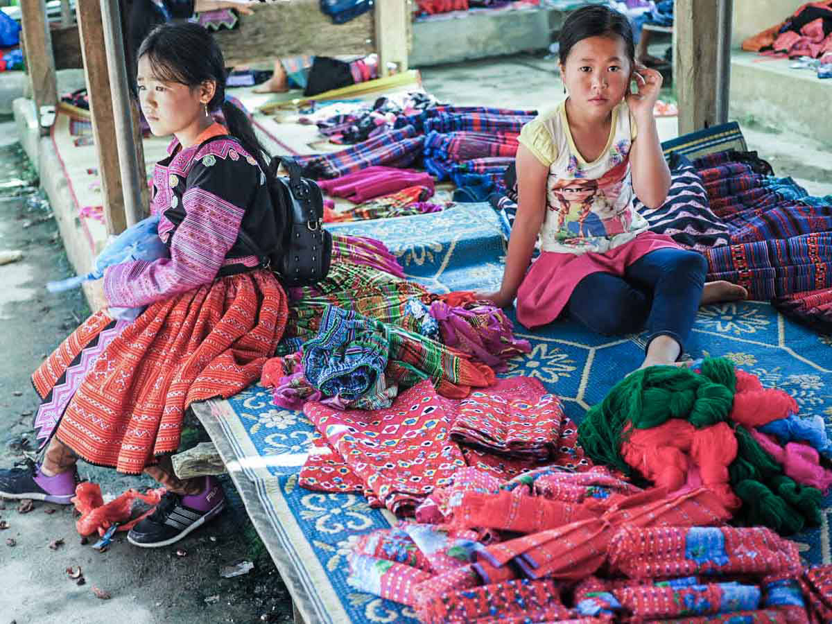 Hmong ethnic market in Pa Co village, traditional clothes of Hmong people, handmade embroidering