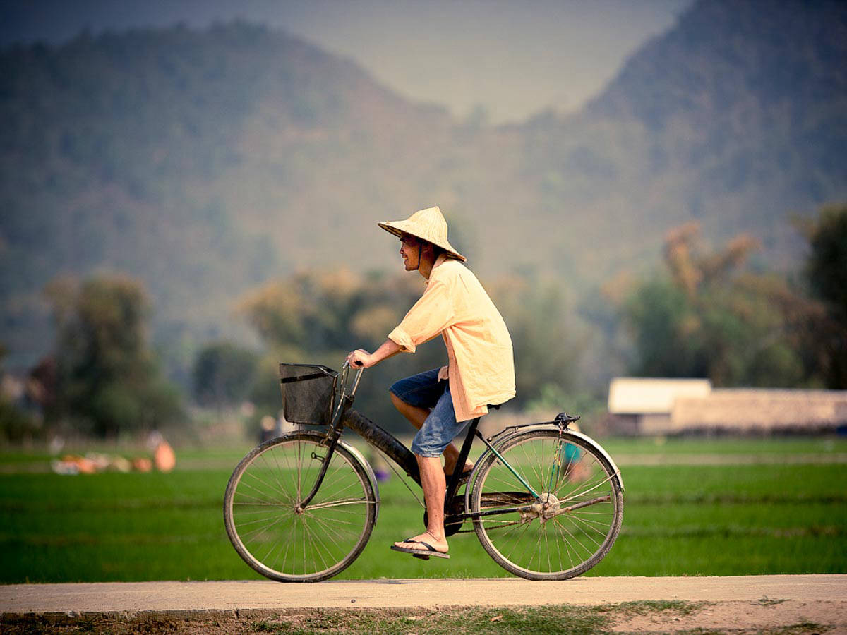 Farmer on a bicycle in Mai Chau village, Vietnam.